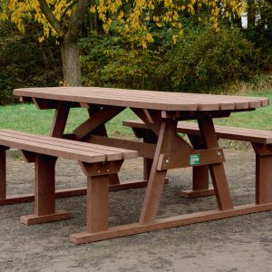 Brown Sturdy Picnic Bench with extended top on grass